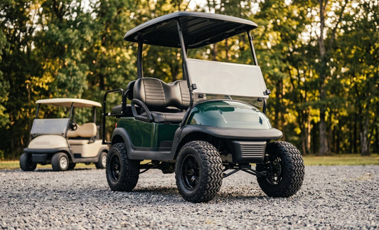 A lifted green golf cart on tall all-terrain tires showing wide clearance between tire and body, with a standard unlifted beige cart behind for comparison