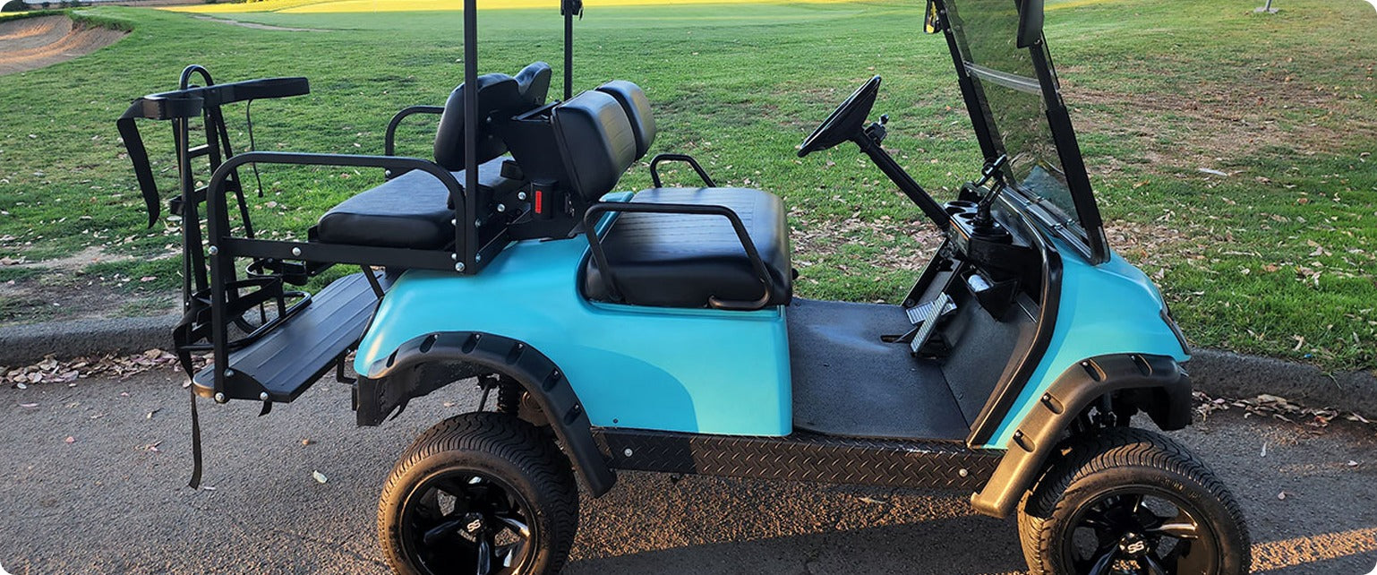 A lifted Top Spinner golf cart parked on the golf course